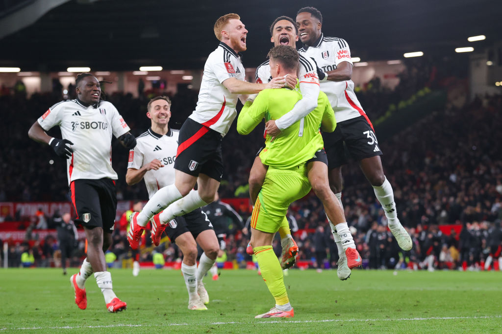 Fulham goal keeper Bernd Leno is mobbed by team mates after winning the penalty shoot out against...