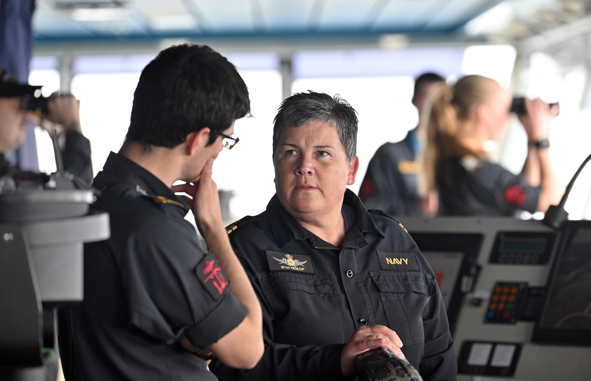 Cmdr Heslop works with junior ranks on the bridge of HMNZS Canterbury.