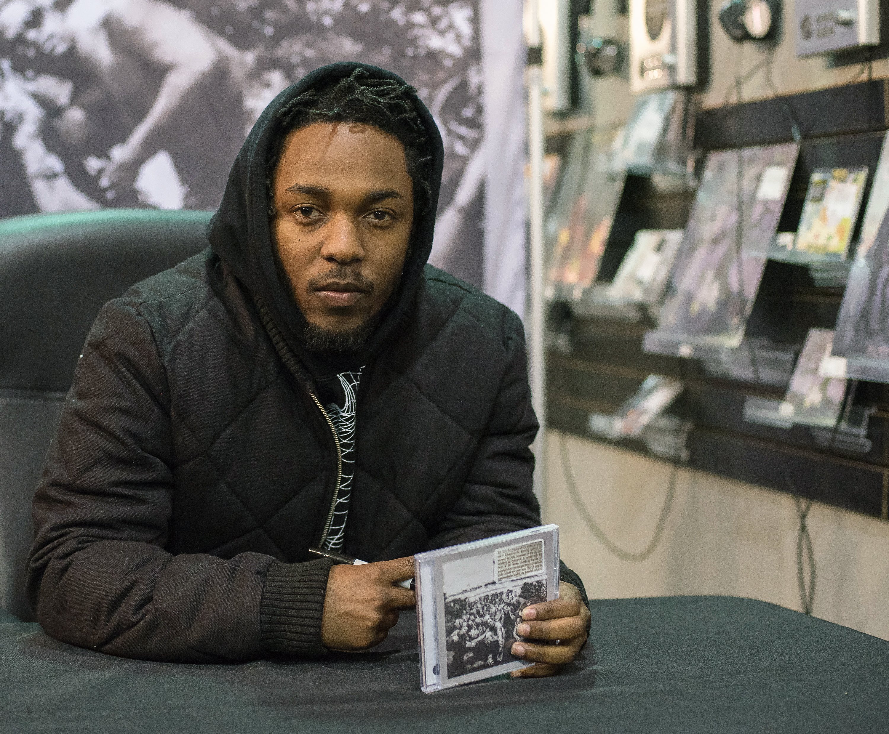 Kendrick Lamar signs copies of his album To Pimp A Butterfly in 2015. PHOTO: GETTY IMAGES