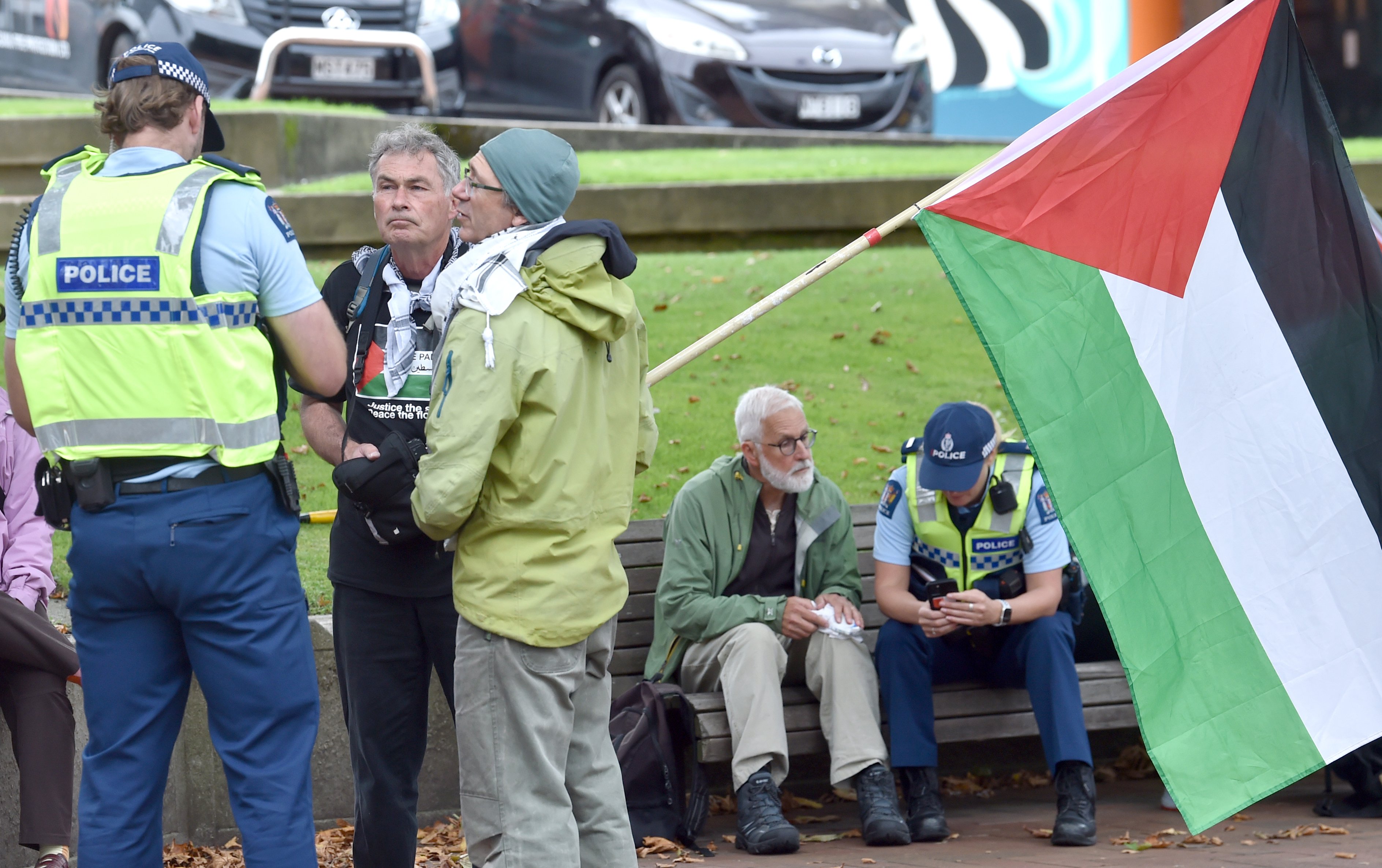 Police speak to protesters after two men were assaulted at a rally in Dunedin’s Octagon yesterday...