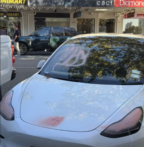 A photo of a Tesla marked with spray paint posted on Reddit with the caption 'Ouch, spotted on...