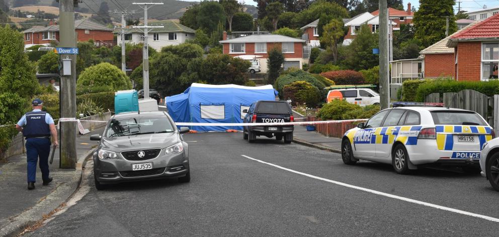 A team of forensic specialists and police at the cordoned-off Pine Hill home. Photo: Stephen...