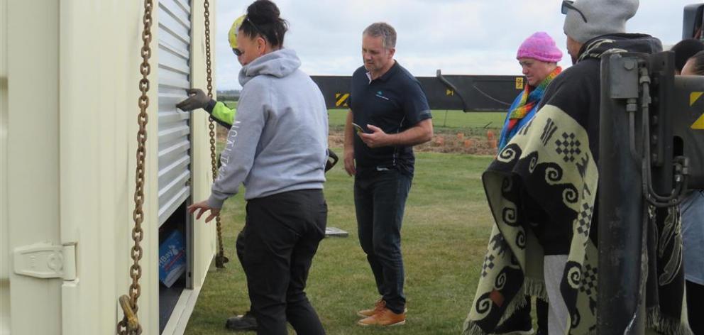 Opening the door to reveal the contents of the emergency pod at the marae were (from left) Andrea...