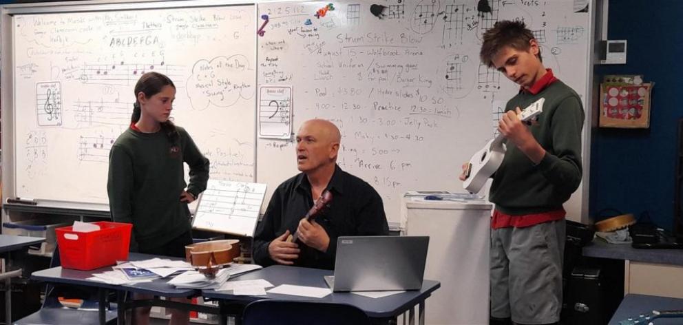 Teacher Dayle Stoliker gives ukulele instructions to budding musicians. Photo: Ashburton Courier