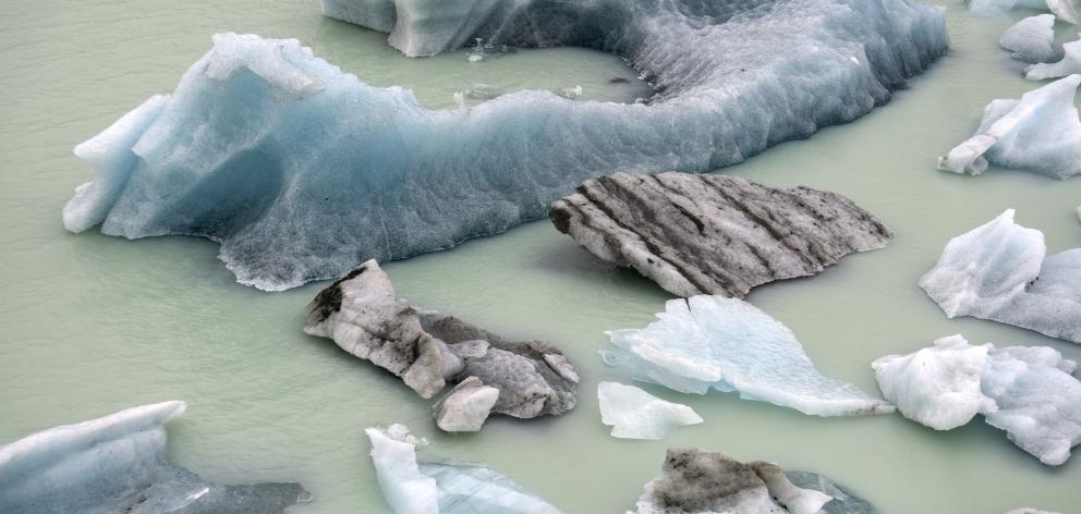 Ice from the Tasman Glacier accumulates at the terminal lake outfall, paused before oblivion.
