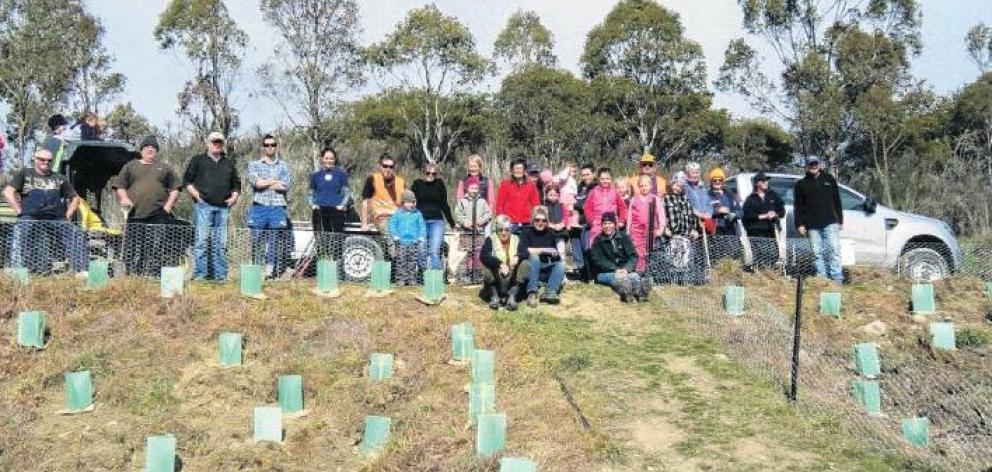 Volunteers plant trees and shrubs during a Clifton Falls community planting day. Photo: Supplied