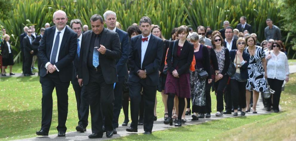 Science and Innovation Minister Steven Joyce (left) and the acting executive director of the Ministry of Business, Innovation and Employment's  Maori economic development unit, Tamati Olsen (right), lead other attendees on to Otakou marae yesterday for th