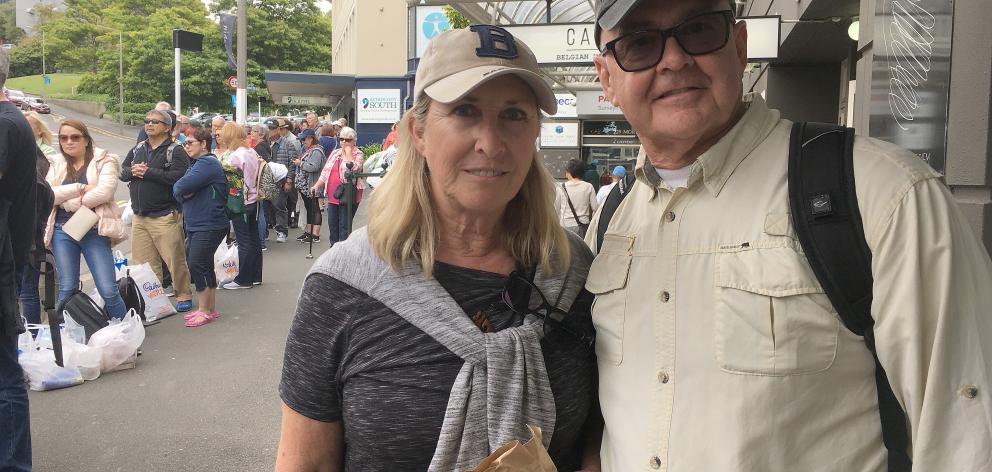 Diamond Princess passengers Dave and Peg Kimball, of Arizona, wait for a bus in Moray Pl yesterday. Photo: Shawn McAvinue