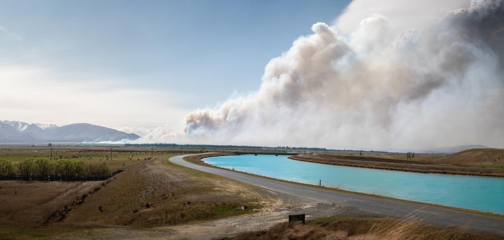 A plume of smoke rises from the Pukaki Downs fire this morning. Photo: Tom Neugebauer