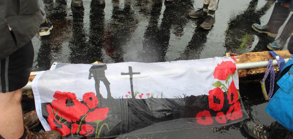 The flagpole is put down while volunteers mark one minute’s silence outside the former McKenzie...