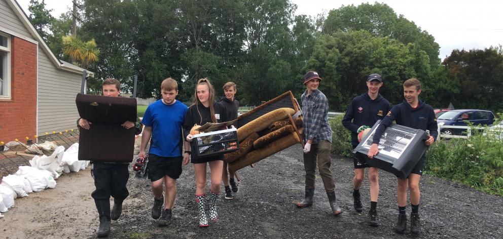 Moving items out of the flooded Hub Youth Complex in East Taieri this week were (from left)...