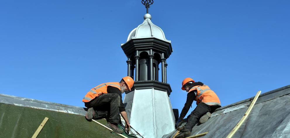 Cameron Roofing specialist slatters Chris Edwards (left) and Blair Allen work on the fleche of...