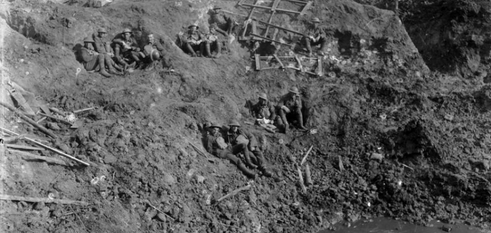 New Zealand engineers rest in a large shell crater at Spree Farm following the first battle of...