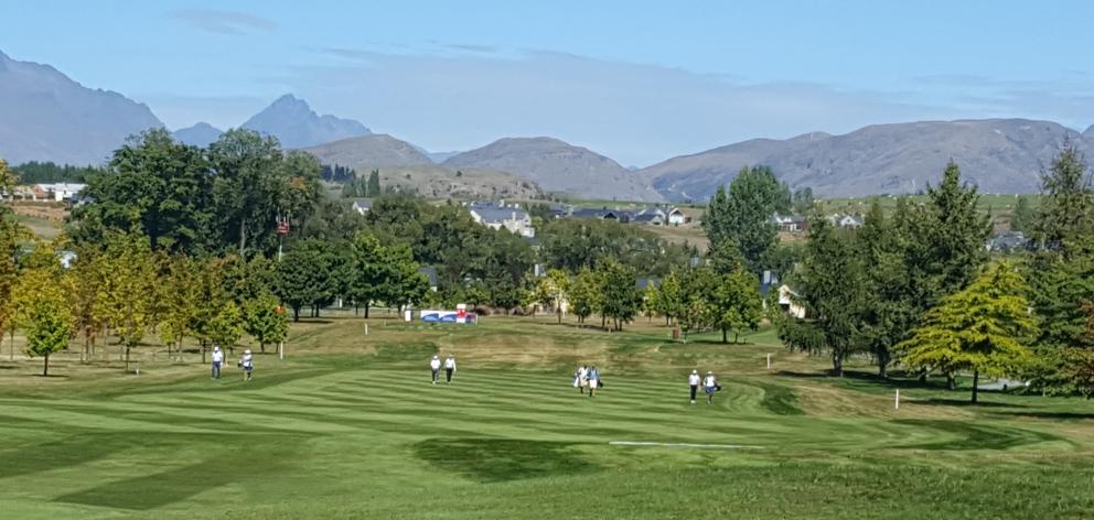 Golfers and their caddies fan out across the lush fairway at Millbrook. Photo: David Loughrey