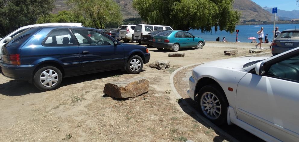 Rocks placed at the edge of grassy areas along Wanaka’s lakefront to prevent parking were moved...