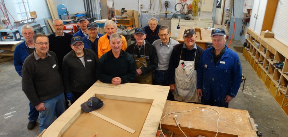 Taieri Blokes’ Shed members gather in the workshop before this week’s 10th anniversary celebrations.Photo: Brenda Harwood