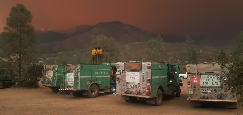 Two members of an international firefighting team waiting for the front to arrive during the...