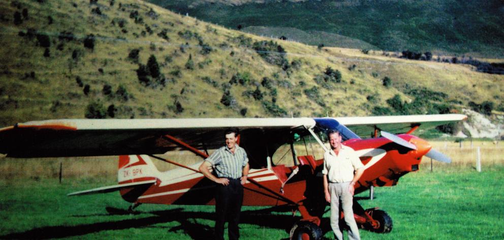 The author’s father (left) takes delivery of his new plane in the mid 1960s.  The hillside in the...