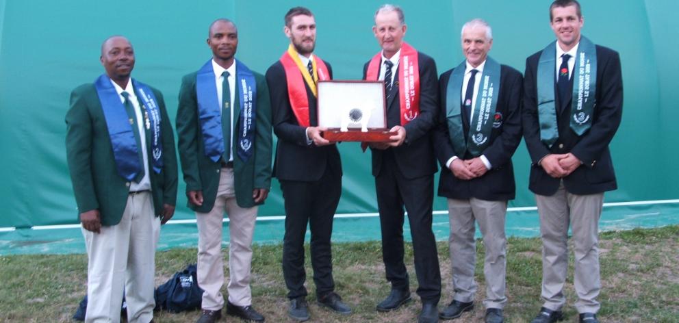 Geraldine's Allan Oldfield, and Fairlie's Tony Dobbs hold the team's world championship trophy. At the left are runners-up Mayenseke Shweni and Bonile Rabile, of South Africa, and, on the right, English father and son team, George and Andrew Mudge. Photo: