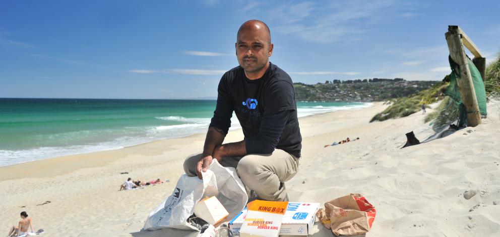 Our Seas Our Future founder Noel Jhinku collects litter at St Kilda Beach yesterday. PHOTO:...