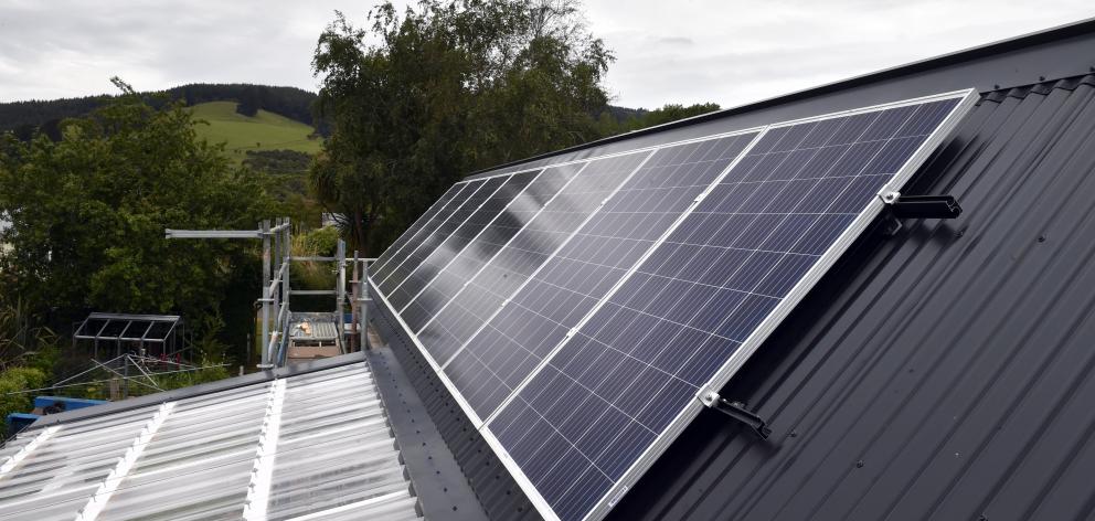 Solar panels on the north-facing section of the roof along with a solar inverter and battery pack...