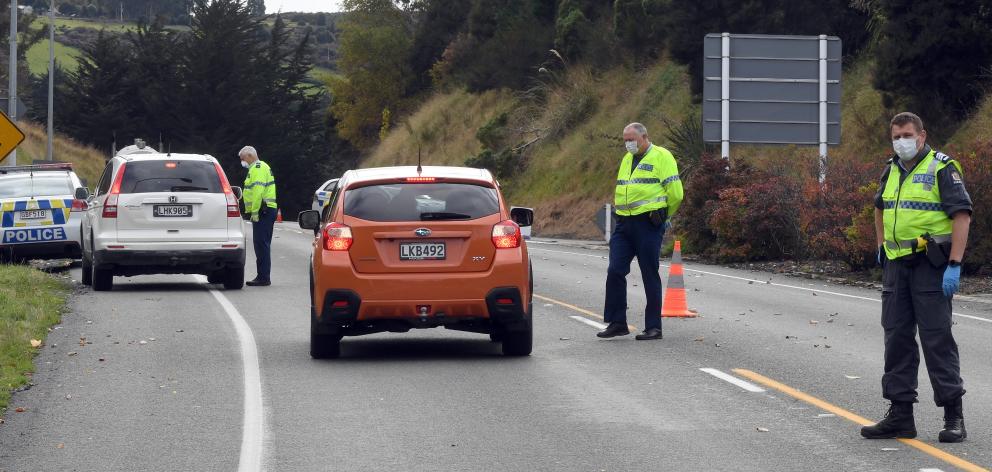 Police at a checkpoint on Dunedin's Northern Motorway on Thursday. Photo: Stephen Jaquiery 