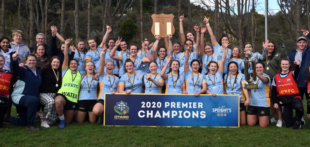 The University women’s team celebrates after claiming its third consecutive premier women’s title...