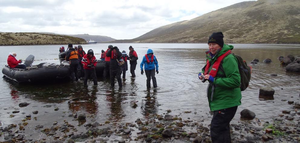 Joanne Laing steps ashore at Tucker Cove on Campbell Island along with other passengers from Spirit of Enderby,which can be seen anchored in the background in Perseverance Harbour. PHOTO:KERRIE WATERWORTH