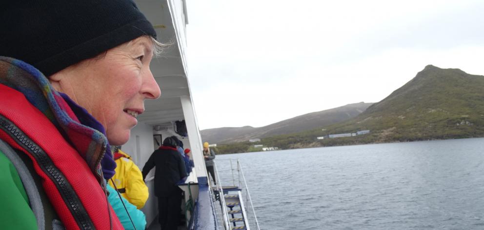 Joanne Laing on the deck of the Spirit of Enderby in Perseverence Harbour opposite the now abandoned Beemer Hill weather station on Campbell island.