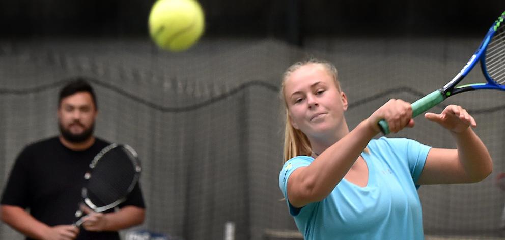 Ivy McLean, watched by Jaden Grinter, hits the ball at the Edgar Centre in Dunedin yesterday....