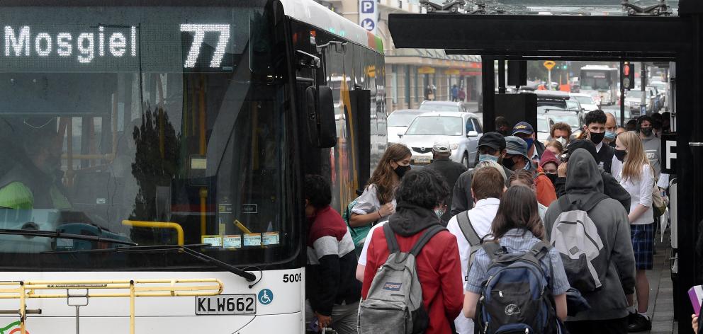 School children and other commuters squeeze on to the Mosgiel bus service at the Great King St...