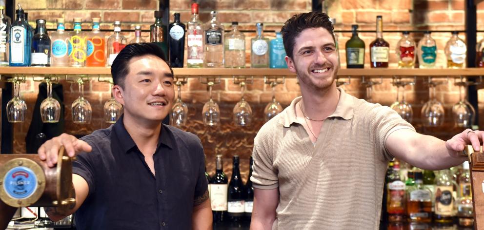 Behind the bar at Vault 21 are (from left) director Andre Shi and operations manager Max Gillies....