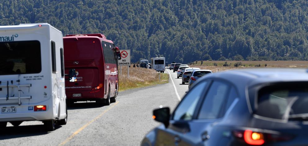 Vehicles pass campervans, buses and people at the roadside. PHOTO: STEPHEN JAQUIERY