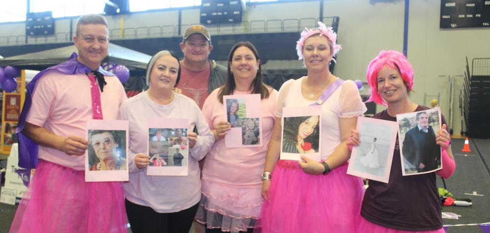 Holding pictures of loved ones who had cancer are, from left, Freddie Muller, Antonette Lexton,...