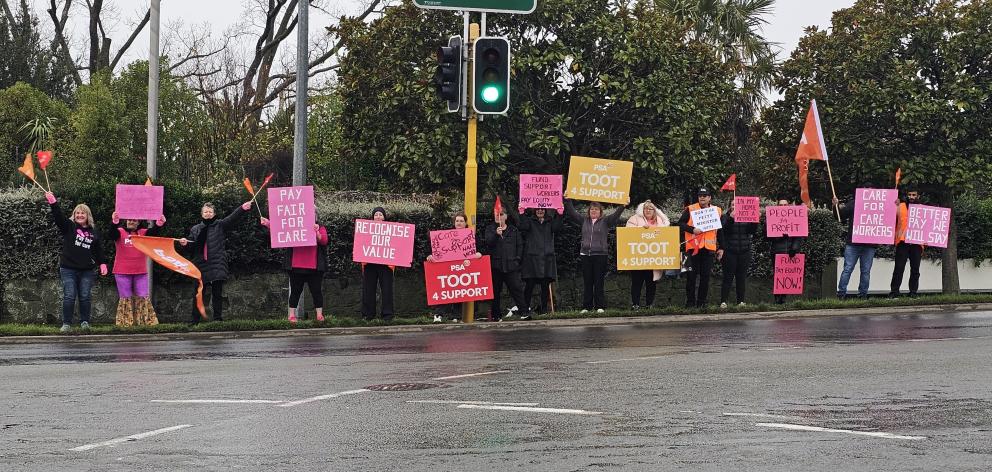 Support workers rally on the corner of Wai-Iti Rd and Evans St on Monday.