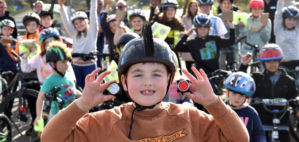 Big Rock School pupil Quaye Driver, 9, with his new bike lights in front of his peers yesterday....