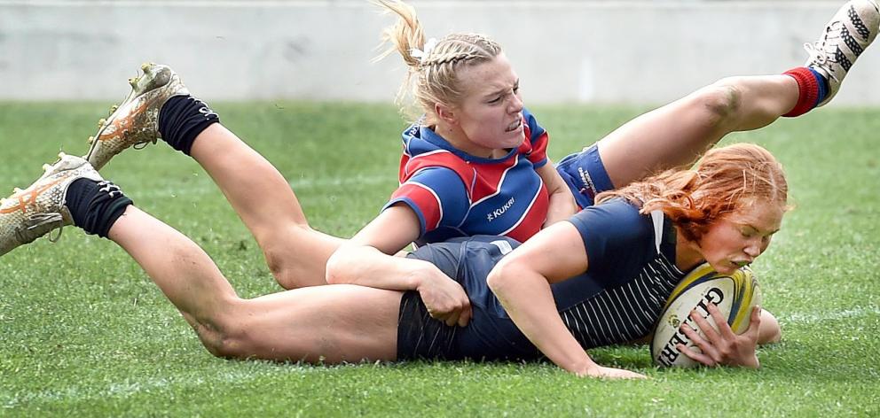 Columba College fullback Pip Eason goes over to score a try while held by Central Southland...