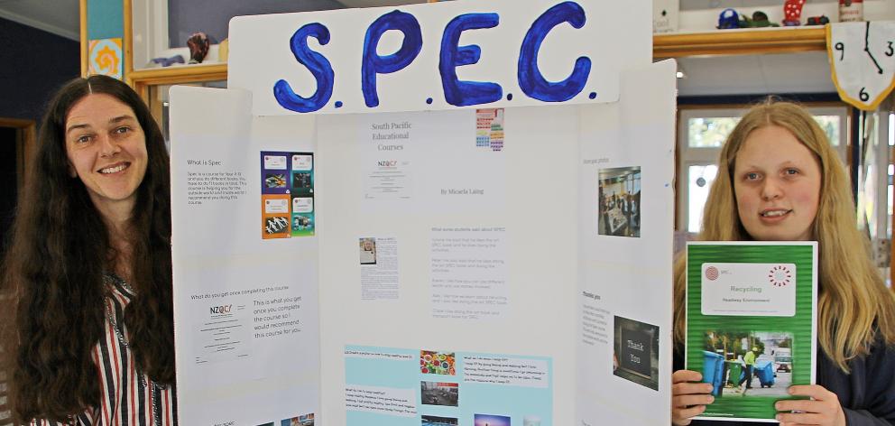 Student Micaela Laing (right) and teacher Jane McEntyre stand by material relating to the South...