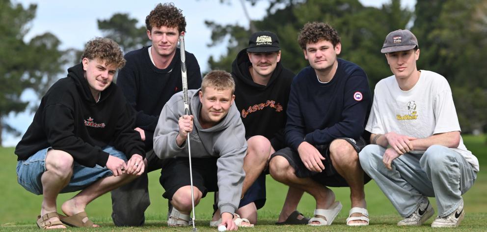 University of Otago commerce student Tommy Cummins, 19, lines up a shot under the eagle eye of...