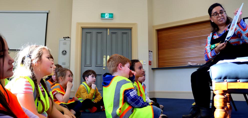 Author Swapna Haddow, of Dunedin, reads her latest book to children from Port Chalmers School....