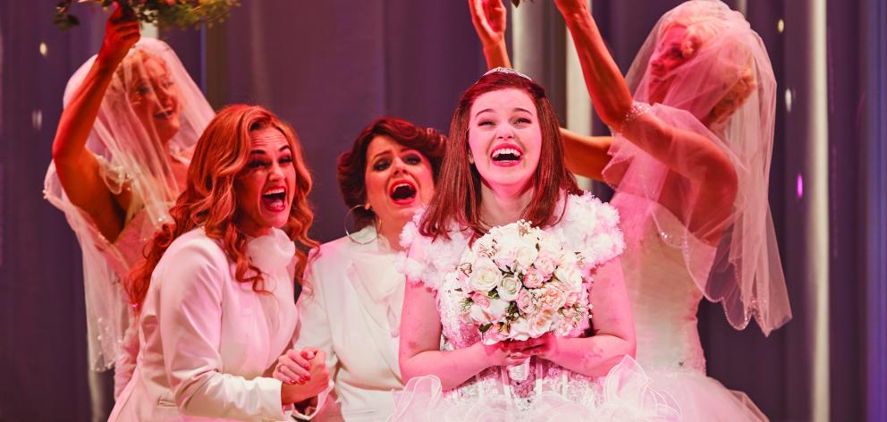 Muriel Hyslop (Maggie McKenna) tries on her dream wedding dress in  a scene from Muriel’s Wedding...