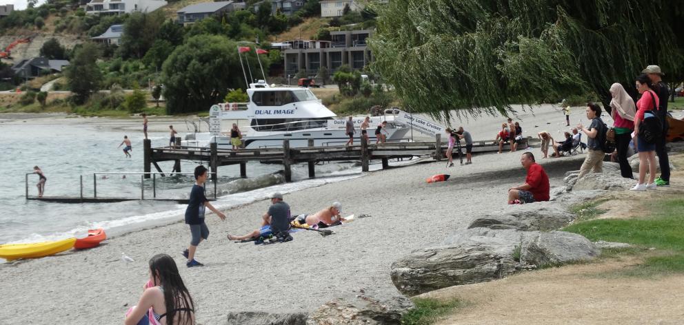 Beachgoers take advantate of warm weather in Wanaka today. Photo: Kerrie Waterworth