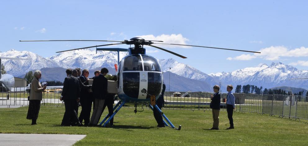 Sir Tim's casket was put into a helicopter to be flown from the airport. PHOTO: STEPHEN JAQUIERY