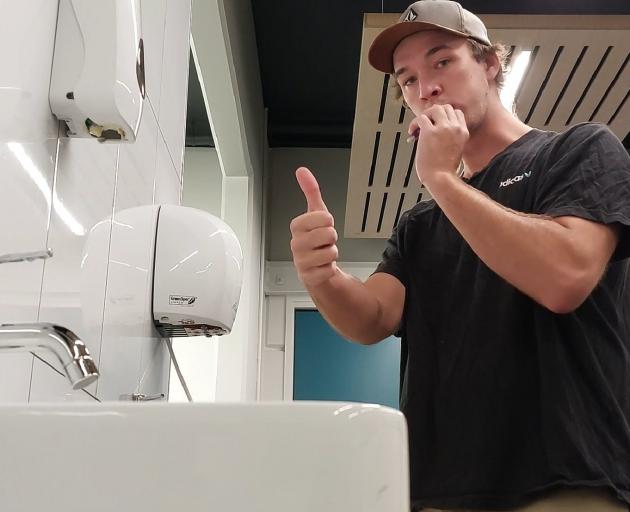 Mr van Onselen brushes his teeth at the Queenstown Events Centre before heading to work.