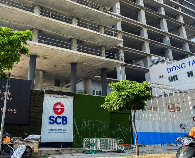 A logo of Saigon Joint Stock Commercial Bank (SCB) is seen in front of an under-construction...