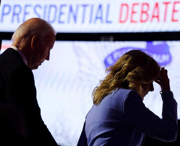 President Joe Biden walks offstage with first lady Dr Jill Biden at the conclusion of a shaky...