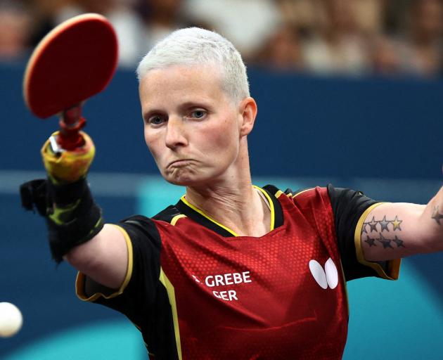 German table tennis player Stephanie Grebe competes in the mixed doubles against Norway.