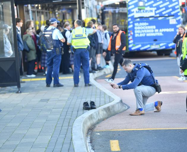 A police photographer at the scene. Photo: Stephen Jaquiery
