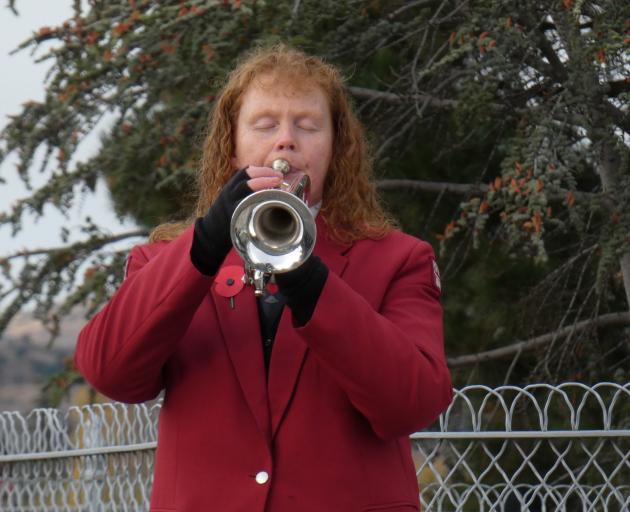 Roxburgh Pioneer Energy Brass Band member Christine Wright plays the Last Post at a wreath laying ceremony at Clyde Cenotaph this morning. PHOTO: SIMON HENDERSON