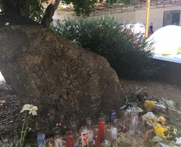 A "Black Lives Matter" shrine, by artist unknown, is flanked by part of David Hammons'...